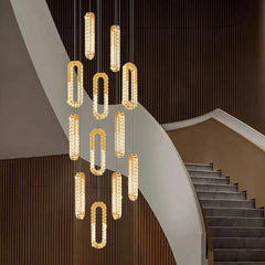 Modern chandelier hanging above a staircase in a stylish interior setting.