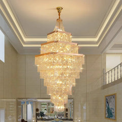 Luxurious chandelier hanging in a room with a staircase and decor.