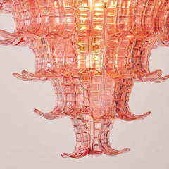 Pink glass chandelier on a light pink background
