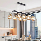 “Nordic black and gold globe chandelier hanging above a modern dining area.”