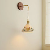 Wall-mounted lamp with decorative shade on a plain wall