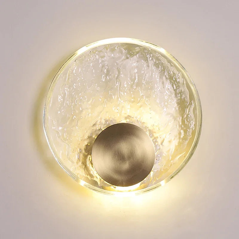 Ceiling light fixture with glass shade and metallic center on a neutral background