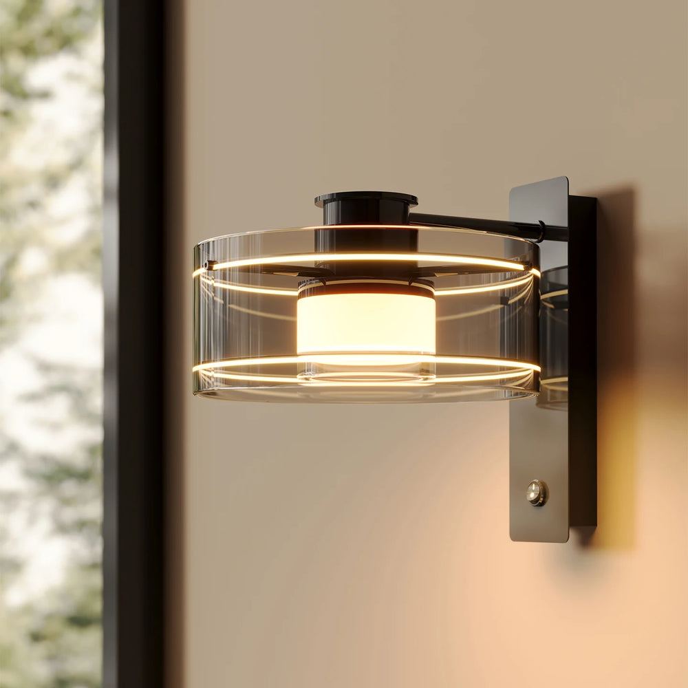 Modern wall-mounted light fixture with glass shade on a neutral background