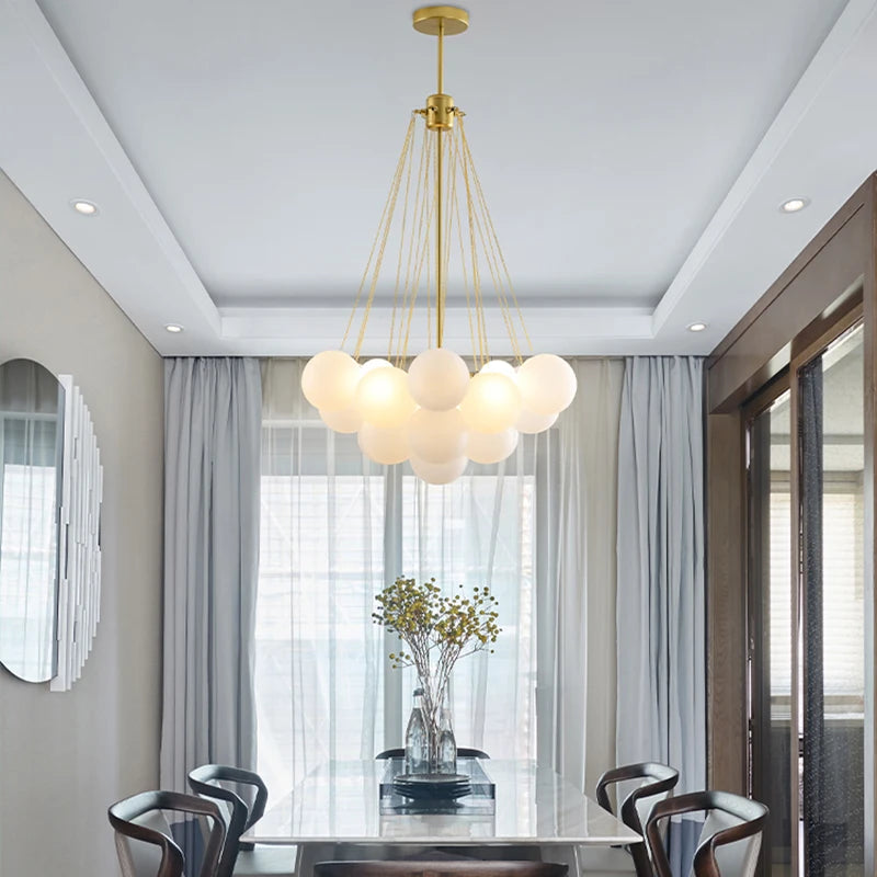 Nordic globe cluster chandelier hanging above a modern dining table