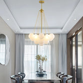 Nordic globe cluster chandelier hanging above a modern dining table