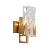 Decorative wall sconce with gold frame and textured glass on a white background