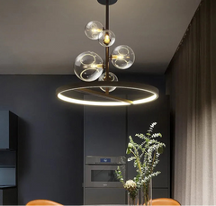 Modern circle pendant light suspended by cord for dining spaces