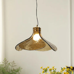 Nordic retro hanging pendant lamp with green glass shade in a moody interior.