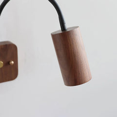 Wooden lamp base with black cord on a light gray background