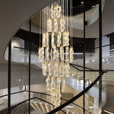 Nordic luxury chandelier with cascading crystal pendants in a modern staircase setting
