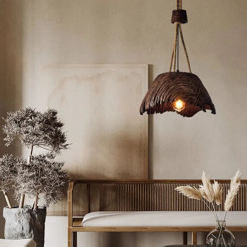 nordic woven pendant lamp hanging above a small dining table