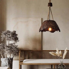 nordic woven pendant lamp hanging above a small dining table