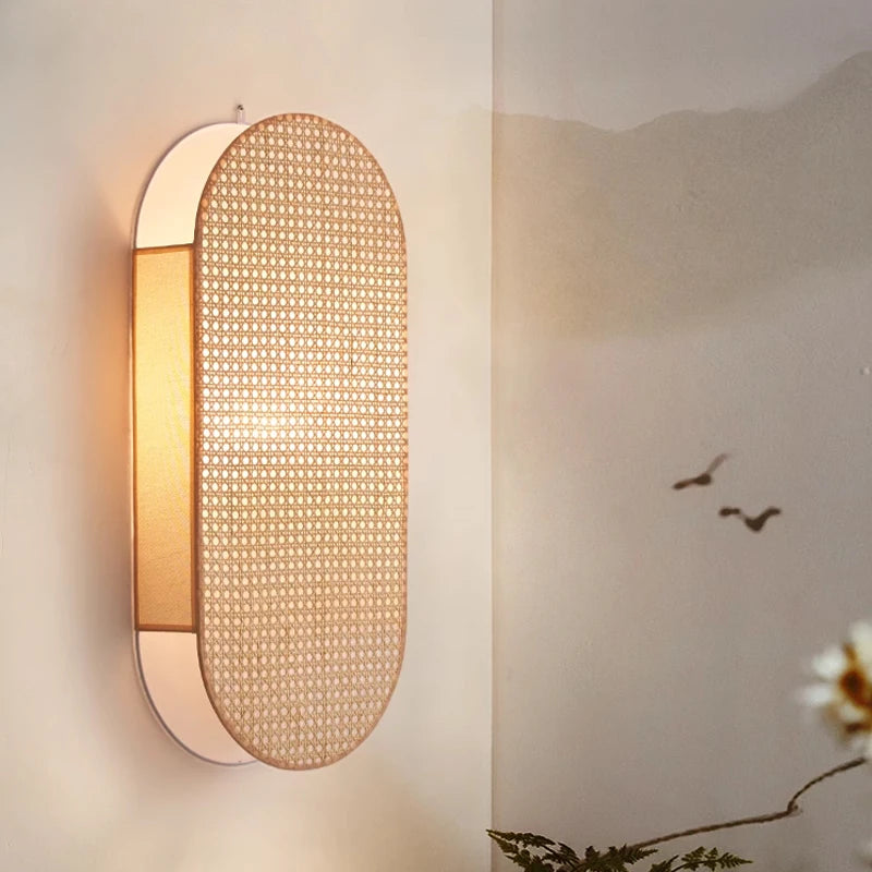 Woven wall light fixture on a neutral wall with a blurred background