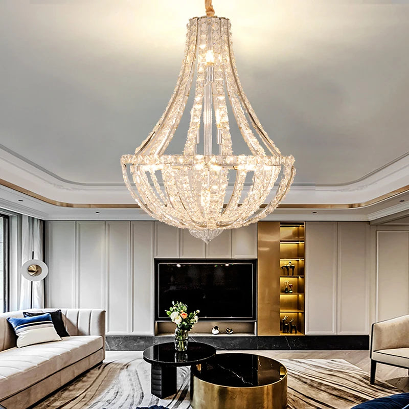 Polished steel chandelier with sparkling crystal shades as a centrepiece above plush seating