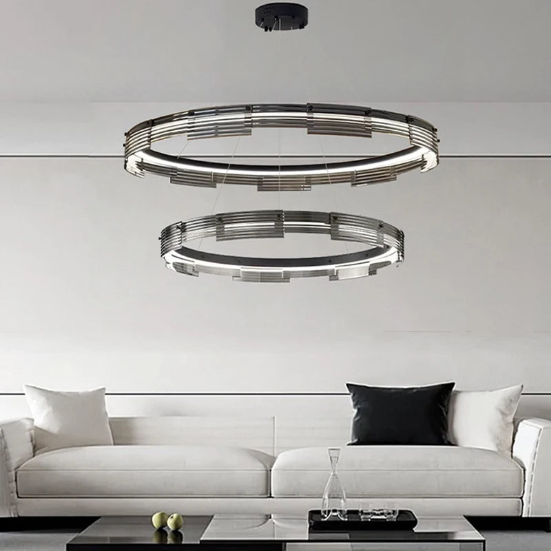 Modern pendant light fixture hanging above a white sofa in a living room setting.