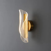 Postmodern wave wall sconce with acrylic shade and metallic backplate on a modern wall