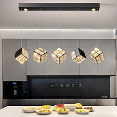 Modern kitchen with decorative pendant lights and a countertop with food.