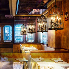 Dining area with wooden walls, hanging chandelier-style lights, and tables set for meals. Crystal pendant chandelier for coffee shop or dining space