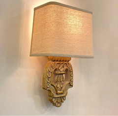 “Retro wall sconce with carved wood and fabric lampshade”