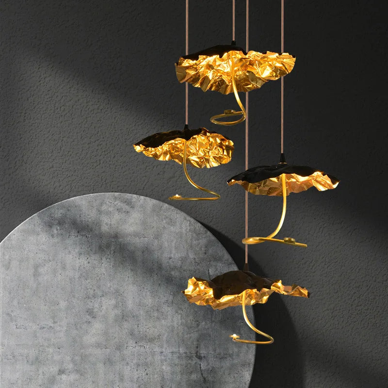 Gold leaf decorative elements hanging against a dark background