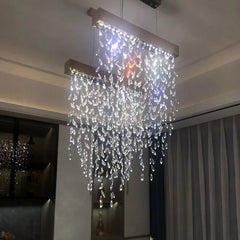 Crystal chandelier hanging from the ceiling in a room with neutral walls.