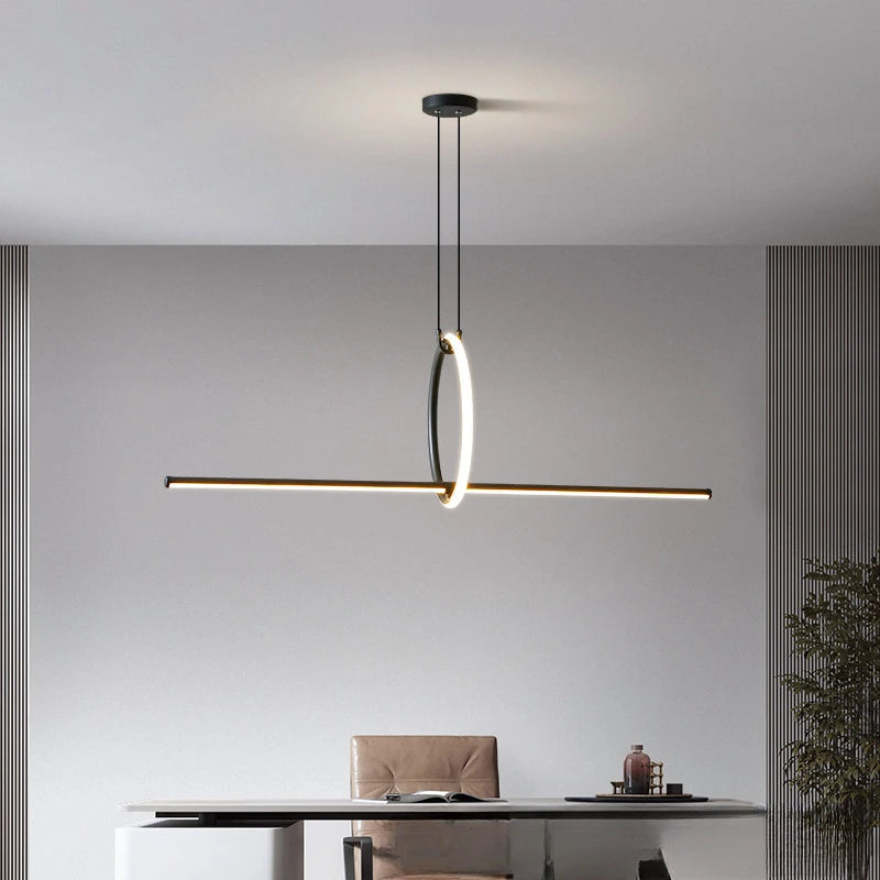 Modern pendant light hanging above a desk in an office setting.