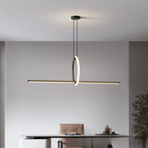 Modern pendant light hanging above a desk in an office setting.
