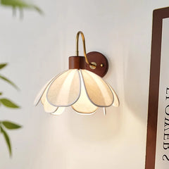 Decorative wall lamp with a flower-shaped shade on a light background