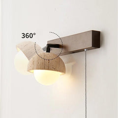 “Rotatable bedside wall sconce casting a warm glow on a minimalist bedroom wall.”