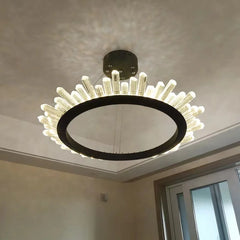 Modern chandelier with black frame and white bulbs hanging from a ceiling.