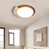 “Travertine and wood flush mount ceiling lamp glowing softly in a modern bedroom.”