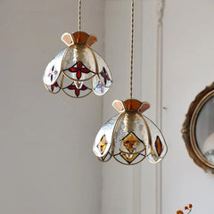Two hanging glass lampshades with stained glass designs on a neutral background. Vintage stained glass LED hallway pendant lamp with diamond cut
