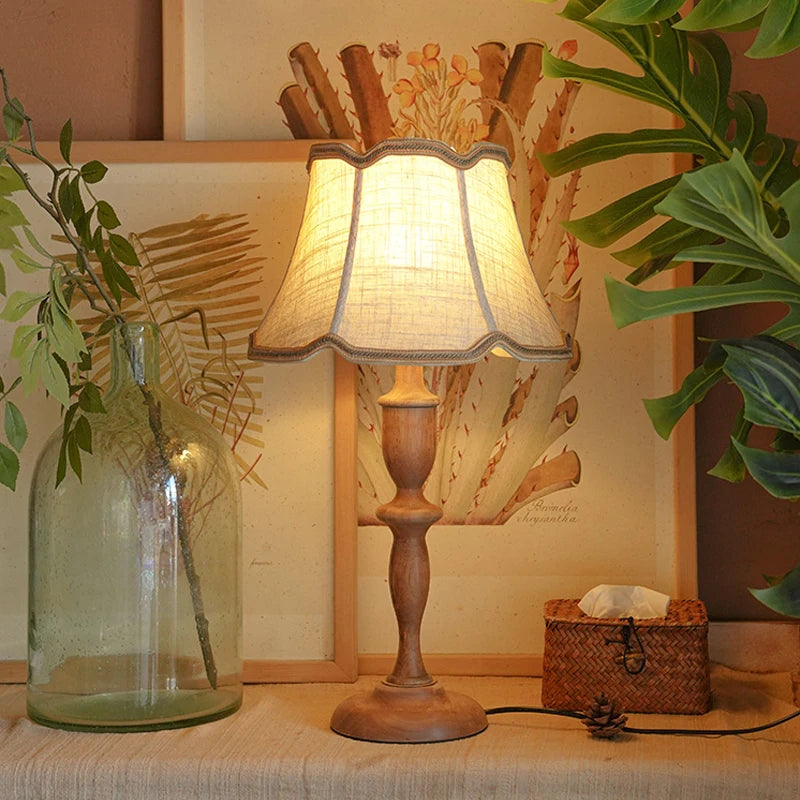 “Vintage bedside light with brown wooden base and classic lampshade”