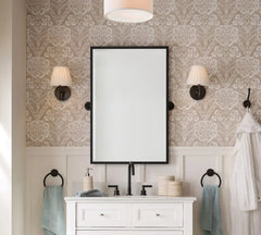 Bathroom with a white vanity, mirror, and decorative wall lights.