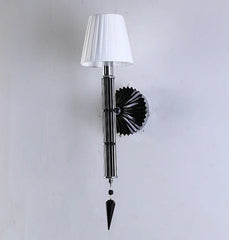 Wall-mounted lamp with a white shade and decorative black base on a light gray background