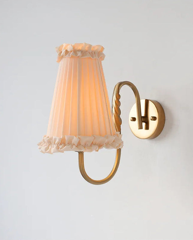 Warm ambient wall sconce with tassel-trim shade for bedroom or hallway lighting