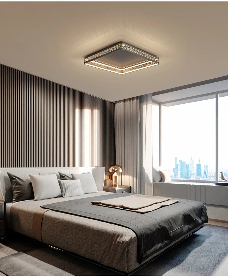 Modern bedroom with a bed, lamp, and large window.