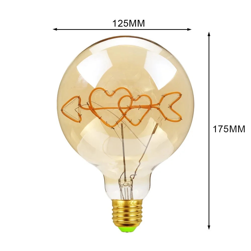 Decorative light bulb with heart and arrow design, shown with measurements on a white background.