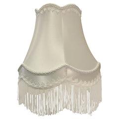 Cream fabric bell lampshade with decorative white fringe and scalloped trim