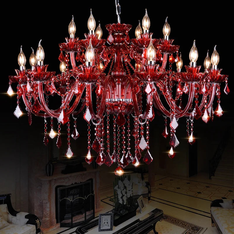 A large, ornate red crystal chandelier with multiple candle-style arms and cascading teardrop crystals against a black background.