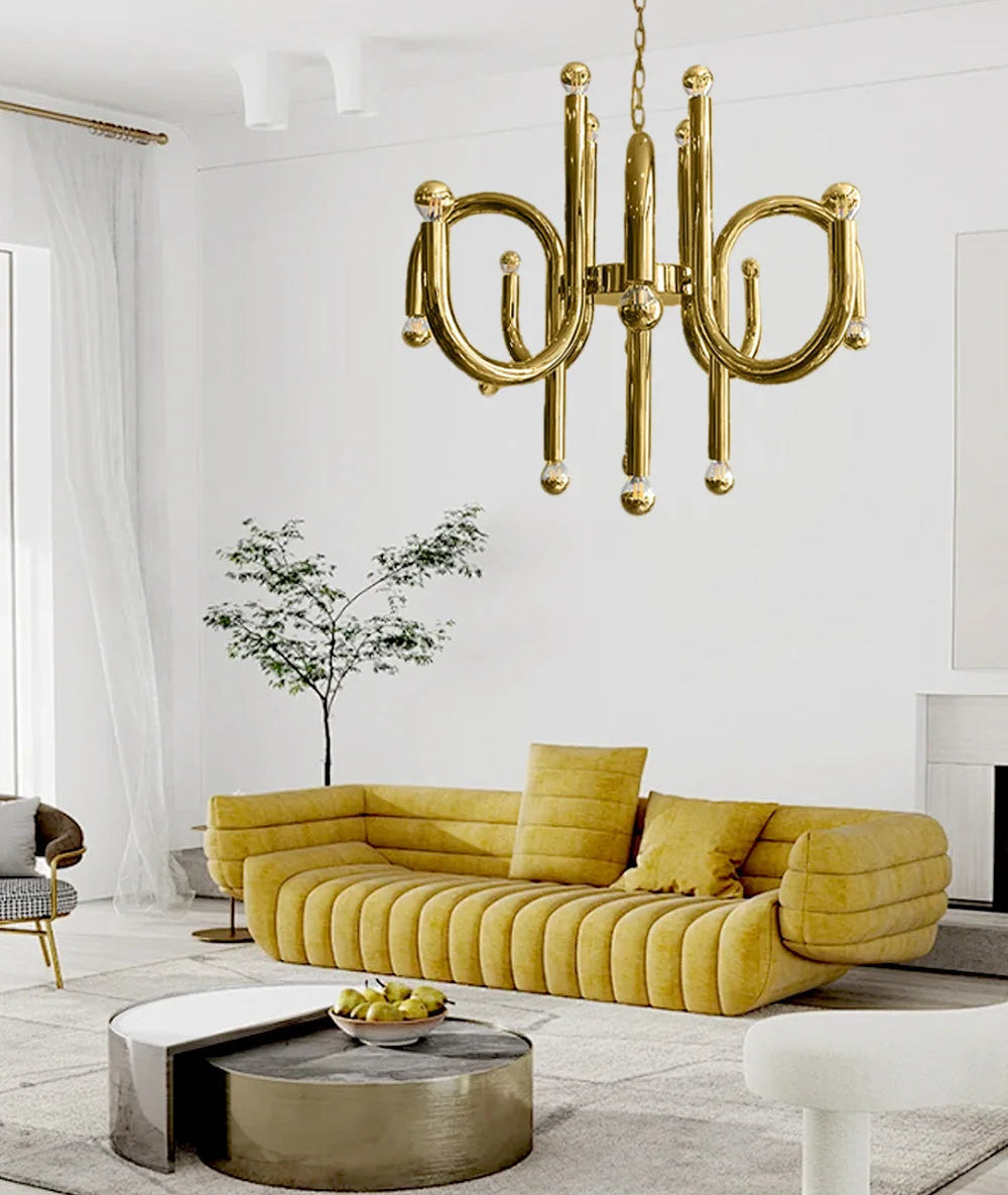 Modern living room with a gold chandelier, yellow sofa, and decorative elements.