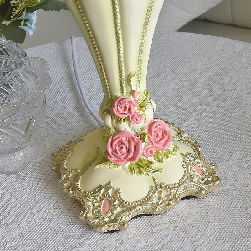 Decorative vase with pink roses on a textured surface