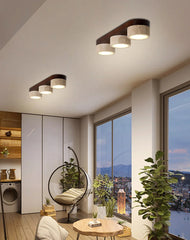Modern living room with ceiling lights, a hanging chair, and cityscape view.