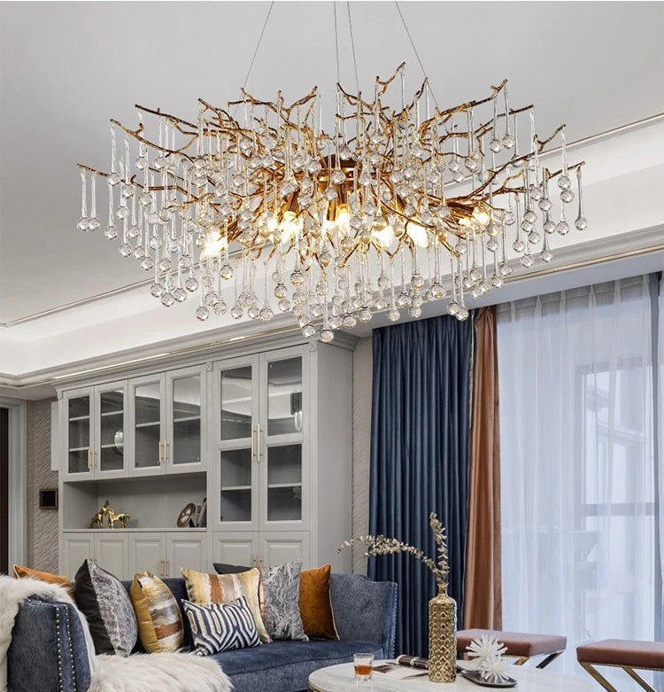 Modern living room with a large chandelier, sofa, and coffee table.