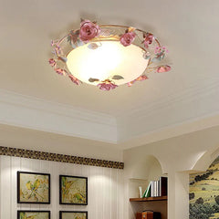 Pink rose bud floral design semi-flush ceiling light installed in a room with framed bird artwork and decorative shelving