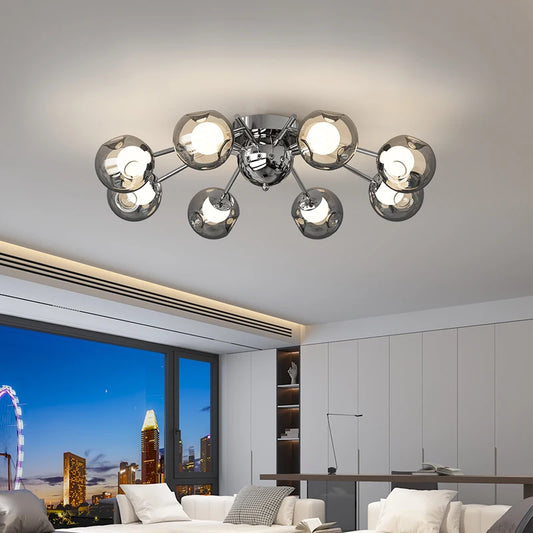 Polished chrome starburst chandelier with multiple glass globes hanging from a central fixture against a white ceiling.