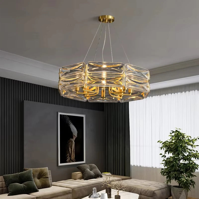 A wider view of a gold and crystal chandelier with stacked cube-shaped crystals in a stylish living area.