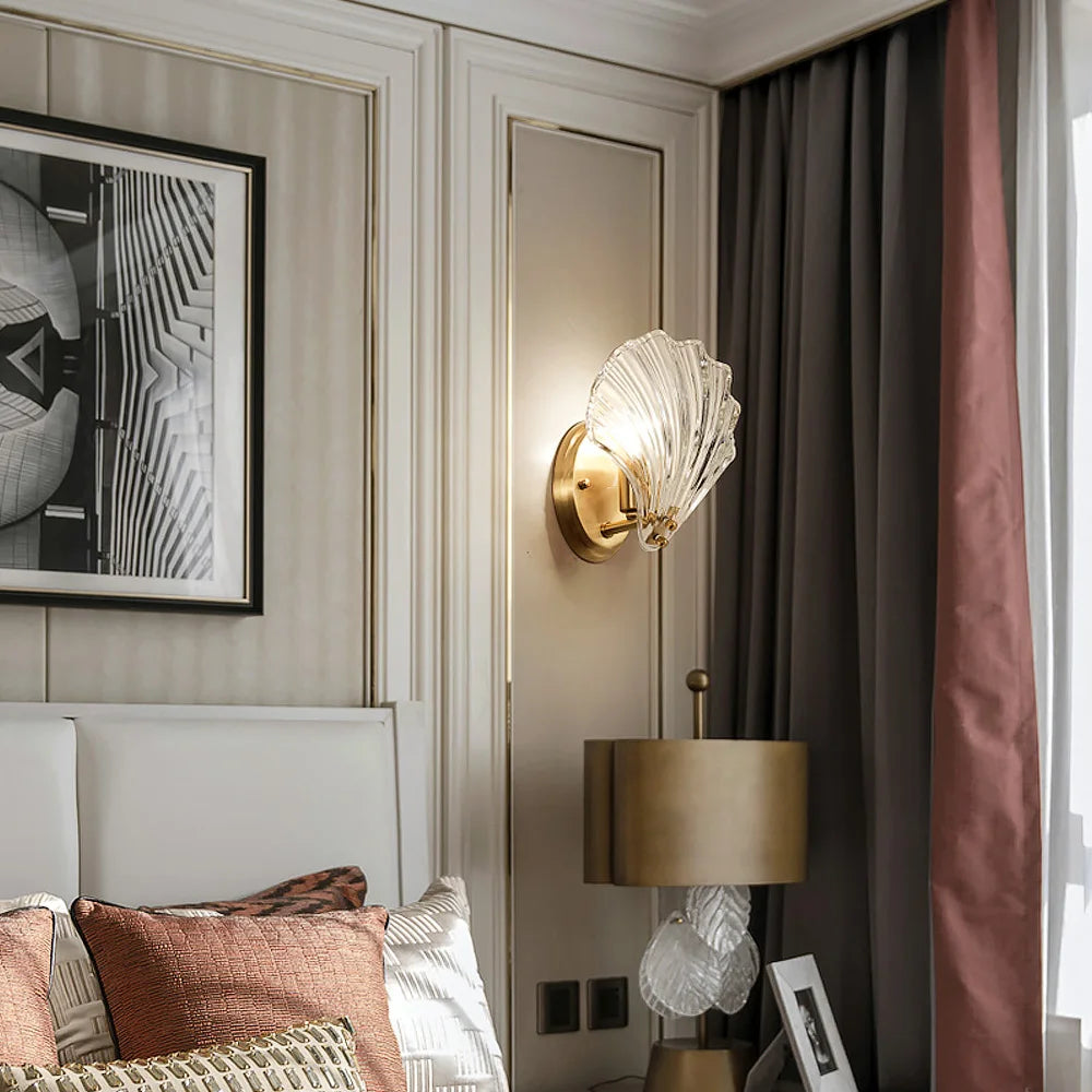 Decorative wall sconce in a bedroom with a bed and artwork.