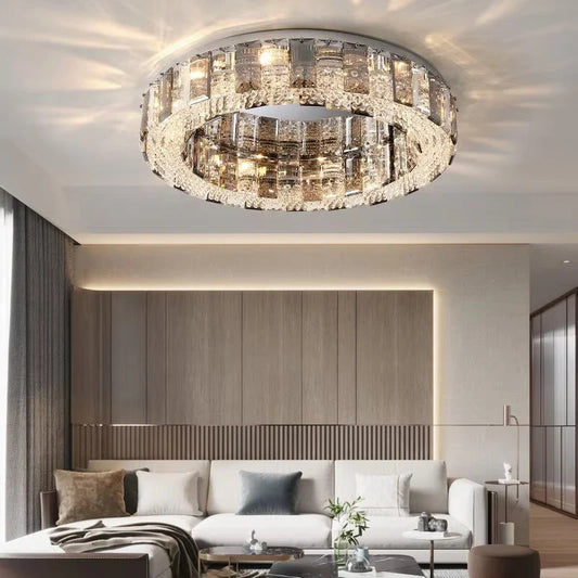Close-up of a modern chrome semi-flush ceiling light with multiple layers of clear and smoky faceted crystals arranged in a ring.