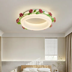 A bedroom interior featuring a white semi-flush ceiling light with a floral rose vine design, illuminated above a bed.
